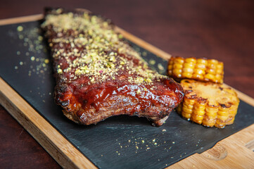 Spicy hot grilled caramelised pork ribs with corn