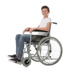 Teen boy in wheelchair on white background