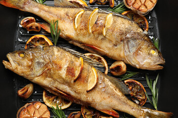 Tasty homemade roasted perches in grill pan, flat lay. River fish