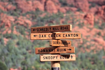 Sedona: focus on direction sign of some mountains, blurred background.