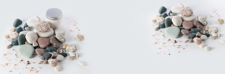 banner, spa relax, stack of round colored stones, sea salt, body peeling cream, on a white background, empty space for text in the middle
