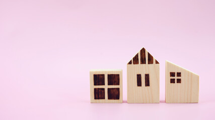 Difference house model on pastel pink background, Planning to buy property.