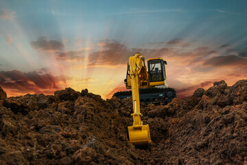 Crawler Excavators are digging the soil in the construction site on the  sunset  sky background