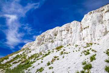 Fototapeta na wymiar White chalk rocks or mountains or hills in chalk steppe, the Dvorichanskyi National Nature Park reserve in Ukraine, Kharkiv region