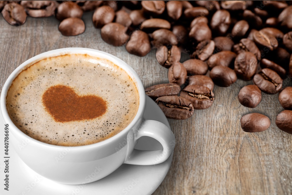 Poster cafes and restaurants. a mug of black coffee with foam in a heart shape and coffee beans.