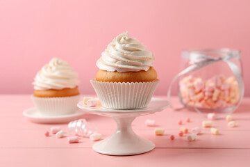 Delicious cupcakes decorated with cream on pink wooden table