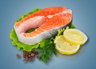 Fresh raw salmon fillet with greens and spices.