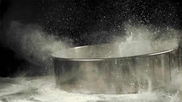 Super slow motion on the table drops a sieve with flour. On a black background. Filmed on a high-speed camera at 1000 fps.High quality FullHD footage