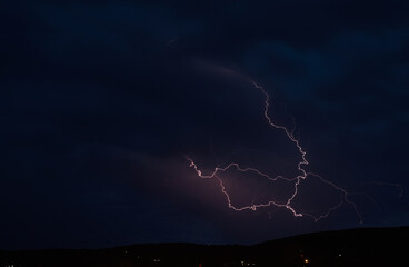 Lightning storm in the dark cloud sky illuminated by the glare of lightning