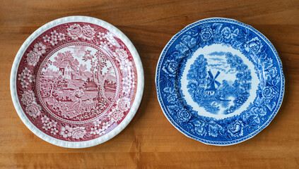 Vintage porcelain plates - china blue and red country scene pattern on a wooden tables