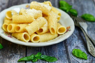  Home made  italian rigatoni   pasta  with parmesan cheese,garlic  and black pepper .Pasta cacio e pepe. Mediterranean food concept
