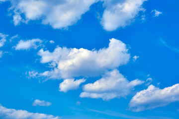 Obraz premium Blue sky with white cumulus clouds. Banner. Background. Nature wallpaper. Sunny weather forecast. Religion concept. Heaven landscape. Outdoor scenic. Bright pattern design. Copy space. Fresh air