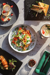 Various breakfast options. Scrambled eggs, cheese cakes, milk porridge, toasts