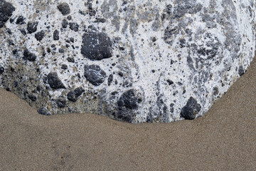 Close Up of Volcanic Conglomerate Rock on Sandy Beach