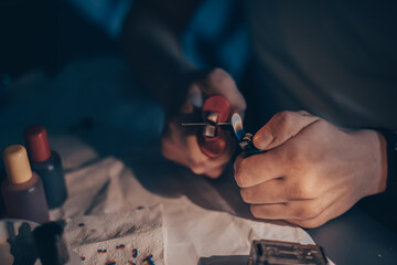 Male hands refill printer cartridge. The guy makes holes in the cartridge and pours ink through the...