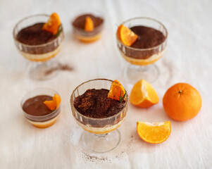 Homemade tiramisu with tangerines on a table