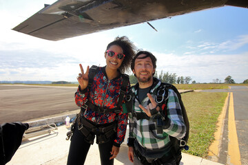 Tandem parachute jump. Beautiful Brazilian woman.