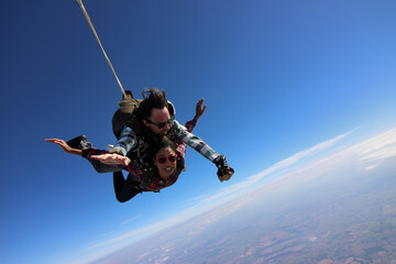 Tandem parachute jump. Beautiful Brazilian woman.