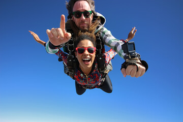 Tandem parachute jump. Beautiful Brazilian woman. - 440796454