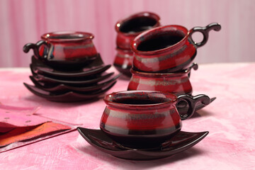 Coffee mugs on a wooden base, lifestyle setting.