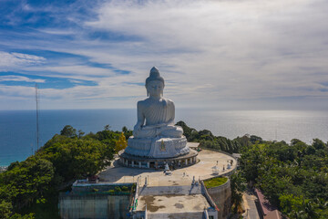 Fototapeta premium aerial photography Phuket big Buddha in sunny day.Phuket Big Buddha is one of the most important and revered landmarks on Phuket island..white cloud in blue sky, blue sea and mountain background