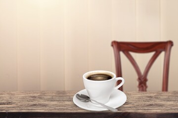 A white ceramic cup of hot black coffee on a wooden table, cafe concept.