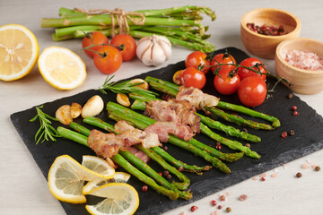Asparagus baked with bacon and spices. healthy food. top view. homemade prosciutto wrapped asparagus with salt and pepper. ketogenic diet. diet menu. Top view, overhead, banner.