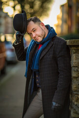 English style. A man walking through the streets of the city. Evening walk. Portraits of people. Headdress-bowler hat