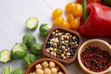 Different vegetables, seeds and fruits on table. Healthy diet..vegetarian, vegan food cooking ingredients. Flat-lay of vegetables, fruit, beans, cereals, kitchen utencil, dried flowers, top view.