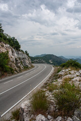 Big empty road with left turn in a mountains