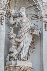 Fototapeta na wymiar Old statue of a sensual Baroque Era woman in downtown of Dresden, Germany, details, closeup.