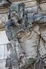 Ancient statute of scary, fearfull and heavy armed gatekeeper, medieval warrior with weapon in...