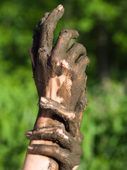 Muddy Hands of a Young Woman