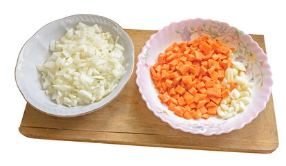 plates with sliced carrots, onions and garlic