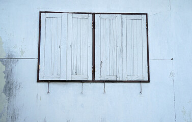 Window of an old white house in Thailand.