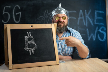 bitcoin cryptocurrency coins in the eyes of a conspiracy theorist sitting at the table holds a...