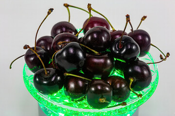 Dark cherries in a bowl with light