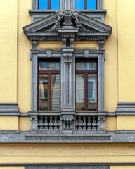 Fototapeta premium Milan Italy, vintage house decorated window and yellow ocher wall