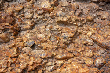 Background texture of brown smooth stones similar to concrete. Horizontal image.