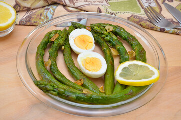 delicious and healthy lunch fried asparagus with boiled egg on a plate