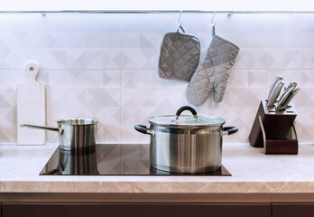 Modern simple kitchen with induction hob and soft lighting
