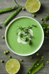 Concept of tasty eating with pea soup on gray textured table