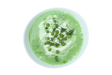 Plate of pea soup isolated on white background