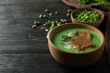 Concept of tasty eating with pea soup on wooden table