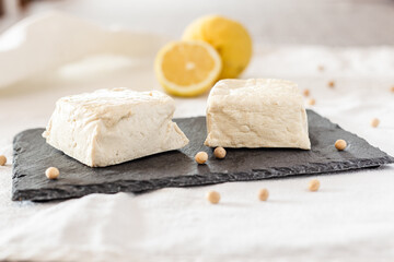 Natural tofu on a black slate dish. Tofu ready to cook. Vegan protein food