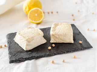 Natural tofu on a black slate dish. Tofu ready to cook. Vegan protein food