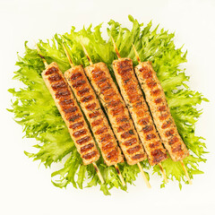 Chevapchichi, meat appetizer on a white background. Lettuce leaves complement the meat dish. Lula-Kebab. Selective focus.