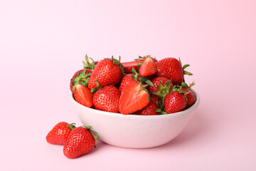 Bowl of fresh strawberry on pink background