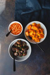 Grilled champignons and pumpkin with thyme in a ceramic bowl. Simple taste recipe.