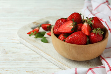 Concept of tasty eating with fresh strawberry on wooden table